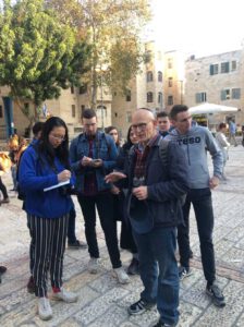 A man explaining to a group about the place they are in