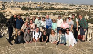 A group of people taking a picture on the mount of olives in Jerusalem