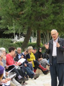 A man explaining to a group about the city