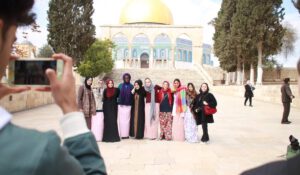 A picture of a group in front of the Dome of the Rock