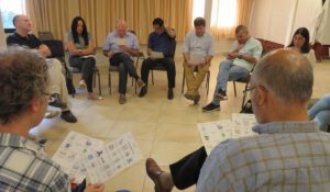 Group of teachers talking in a circle and reading