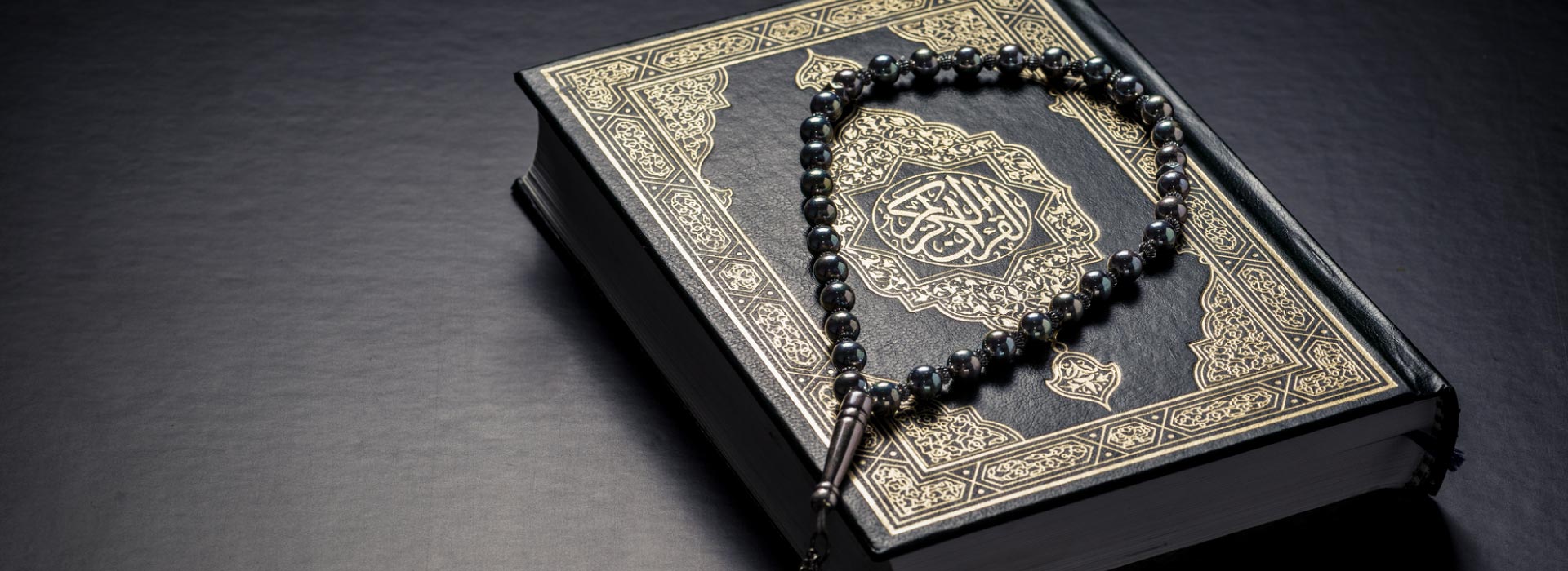 Prayer beads on top of Quran