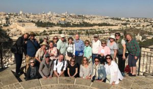 A group of people taking a picture on the mount of olives in Jerusalem