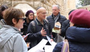 A man explaining to a group about the place they are in
