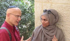 A Jewish man and Muslim woman talking to each other
