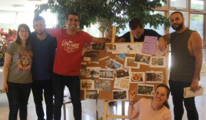 A group of university students showcasing their work on a board