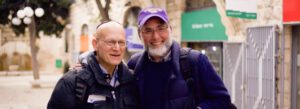 Two men in Jerusalem smiling and walking