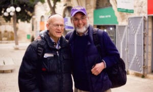 Two men in Jerusalem smiling and walking