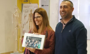 two teachers showing a picture and smiling