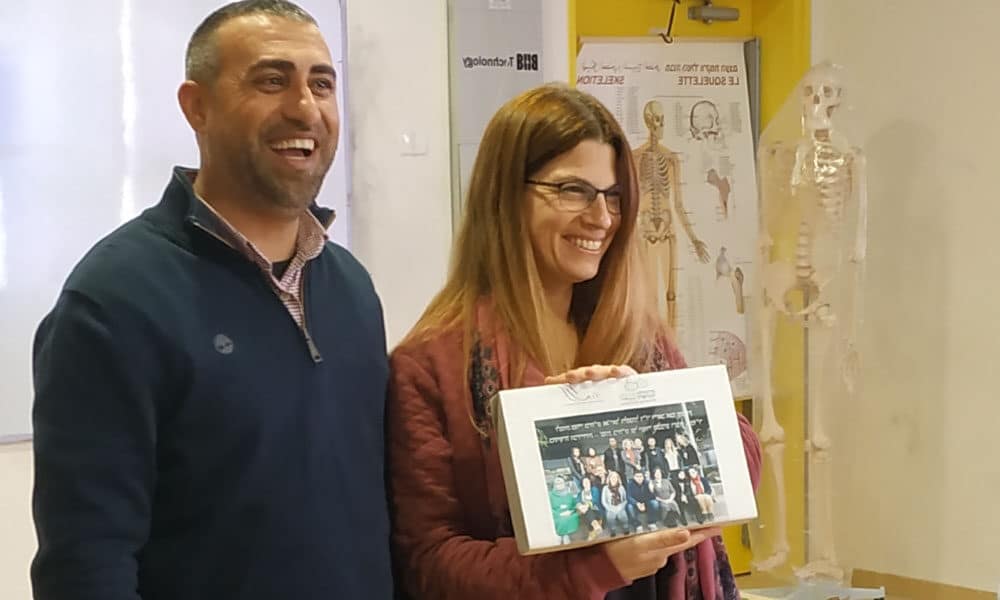 two teachers showing a picture and smiling