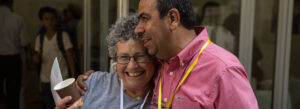 Two people hugging nad smiling