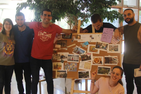 A group of university students showcasing their work on a board