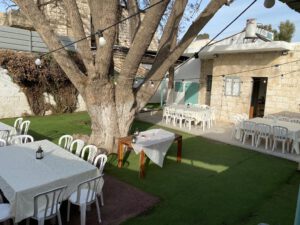 The Open House back garden with tales adn chairs